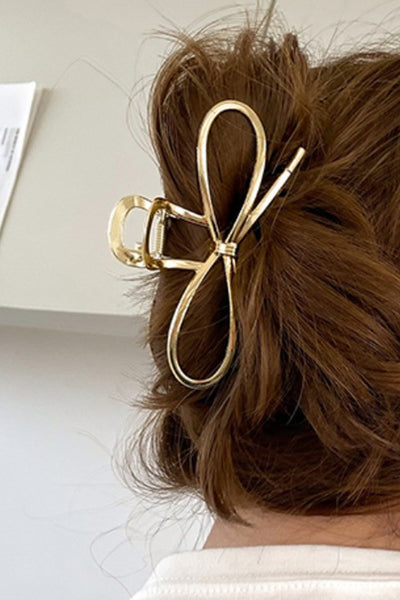 gold bow hair clip in hair