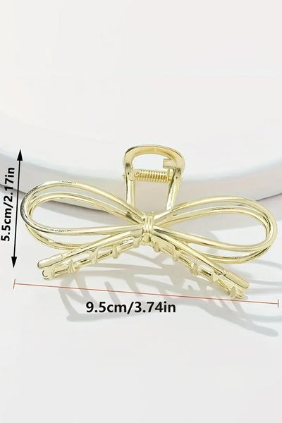 gold bow hair clip with dimensions 2.17" tall by 3.74" wide